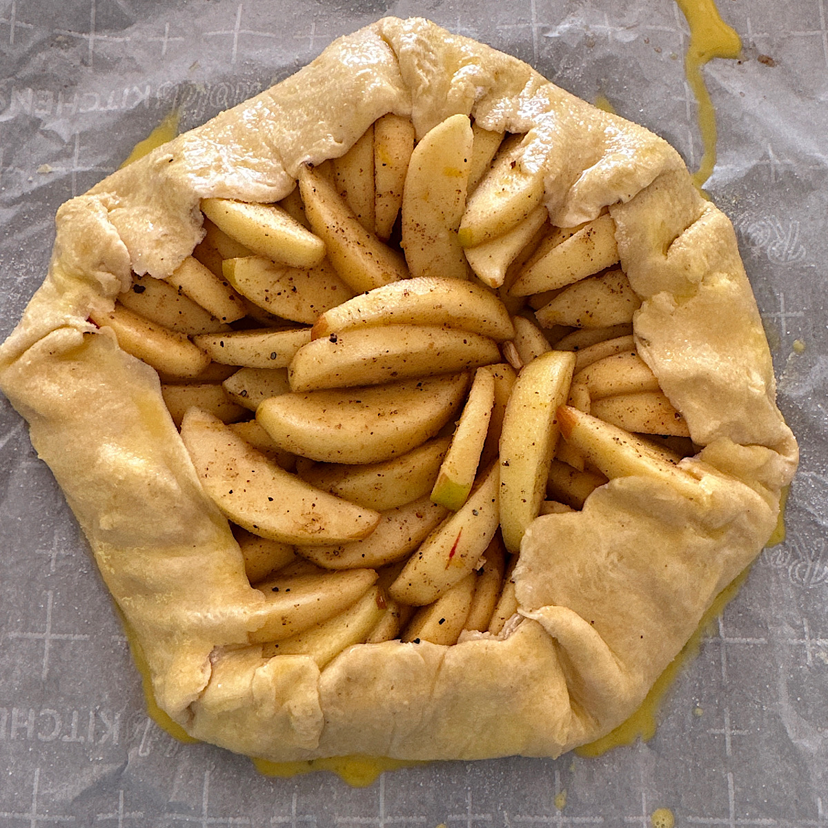 Apple galette prepped on baking sheet before baking