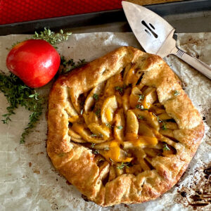 Apple cheddar cheese galette on parchment paper