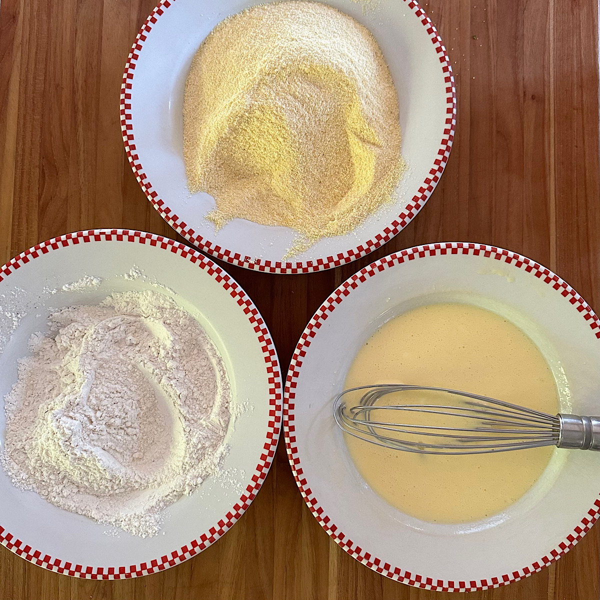 3 bowls in prep for fried green tomatoes: flour, eggs and cornmeal