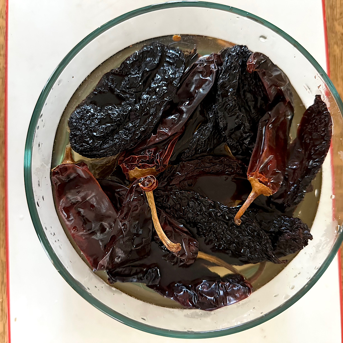 Mix of dried chile peppers soaking in water to rehydrate