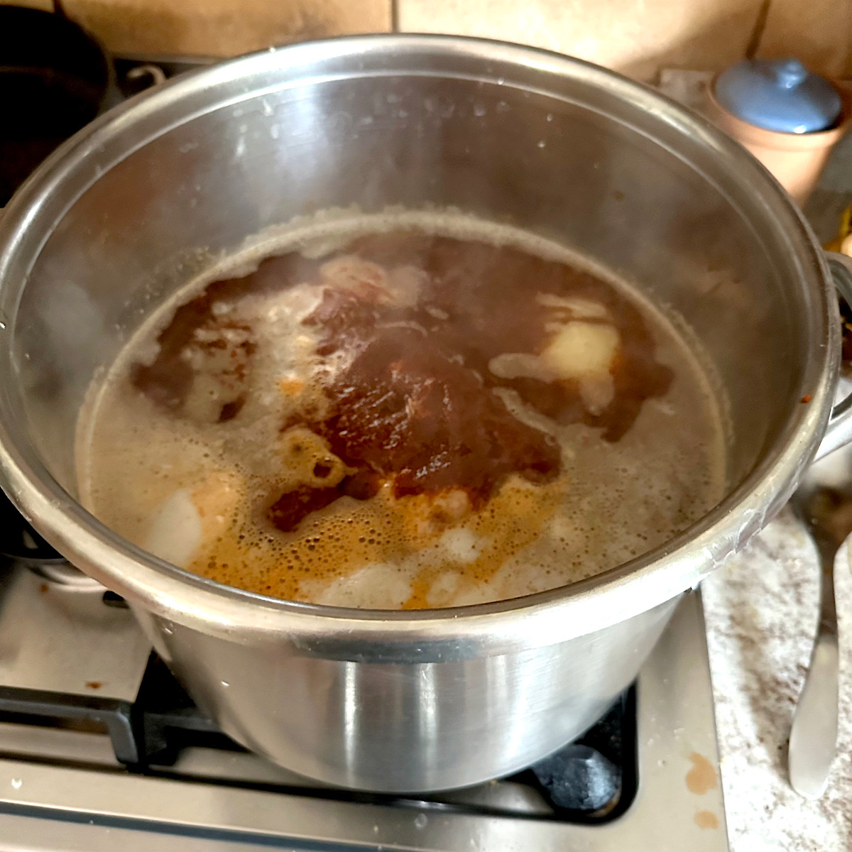 Pork butt, spices and rojo sauce simmering in pot