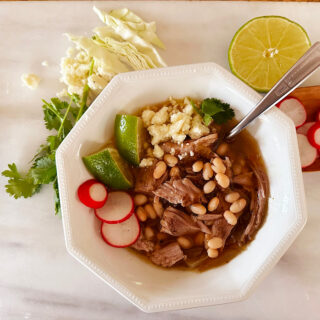 Slow carb pork pozole with navy beans and various garnishes