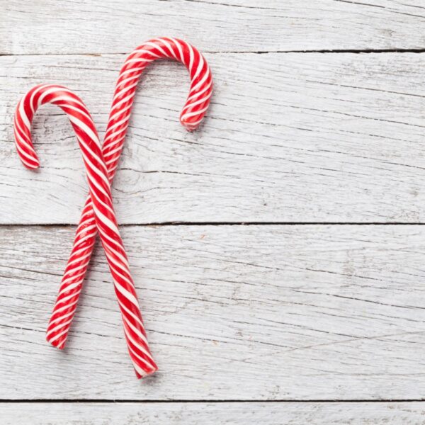 Two candy canes on gray background.
