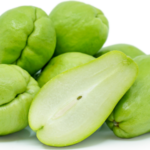 Photo of a few bright green chayote squash with one cut down the middle and showing the seed inside.