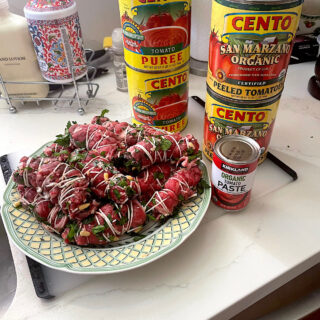 Plate of beef braciola wrapped in twine.