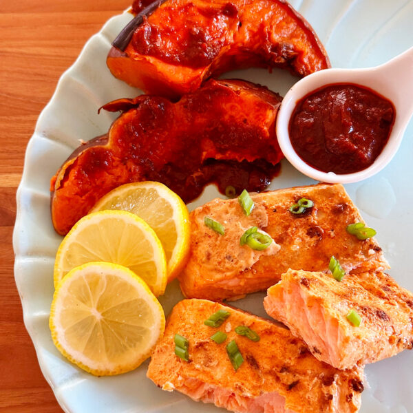 Baked salmon and Winter squash topped with harissa sauce.