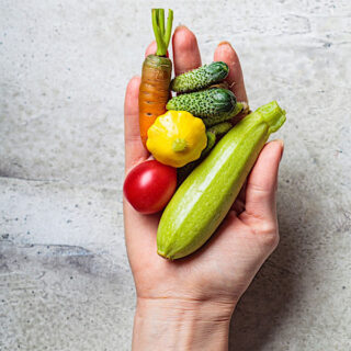 Hand holding miniature vegetables