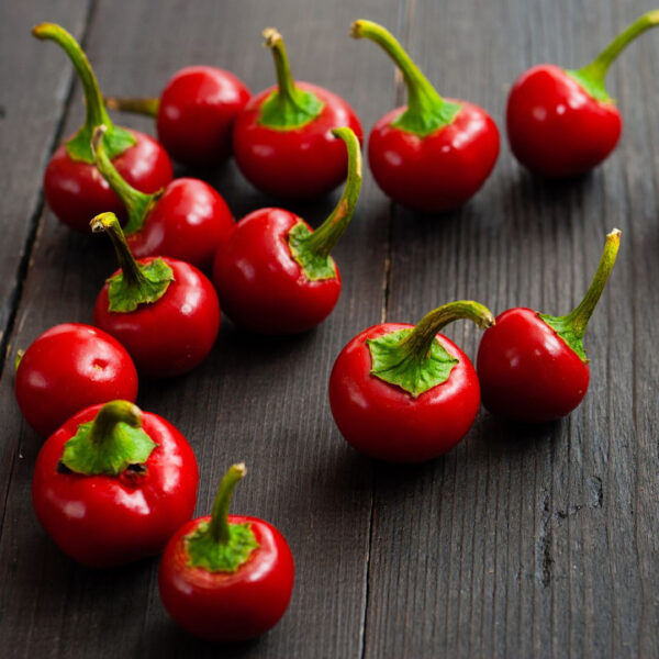 Italian Calabrian chile peppers on a wood board.