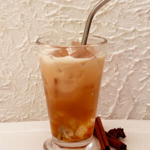 Glass of chai iced tea with straw from Dorothy Stainbrook's Wellness tea collection