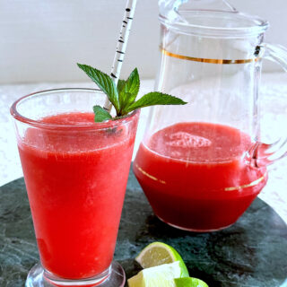 Watermelon agua fresca in glass with sprig of mint