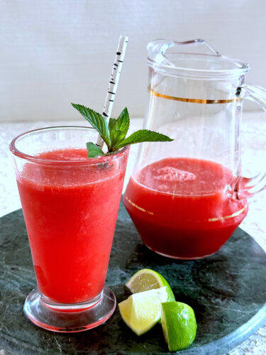 Watermelon agua fresca in glass with sprig of mint