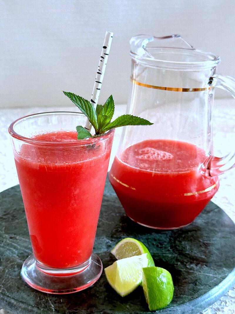 Watermelon agua fresca in glass with sprig of mint