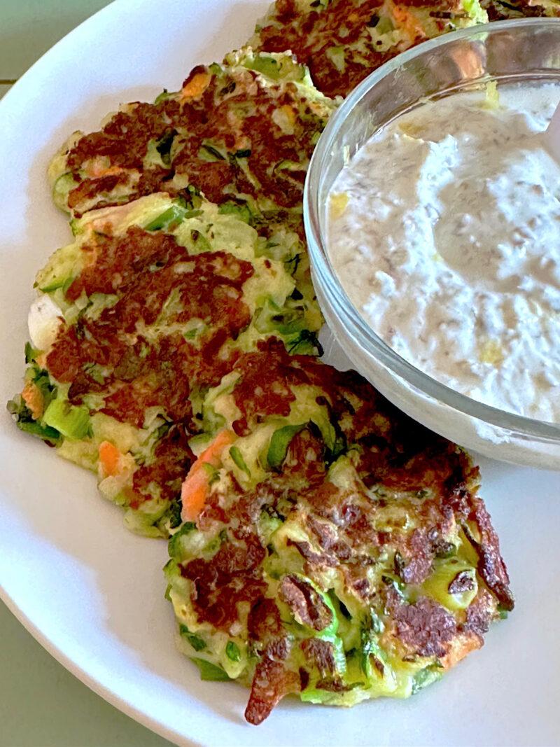 Zucchini fritters with bowl of creamy dipping sauce