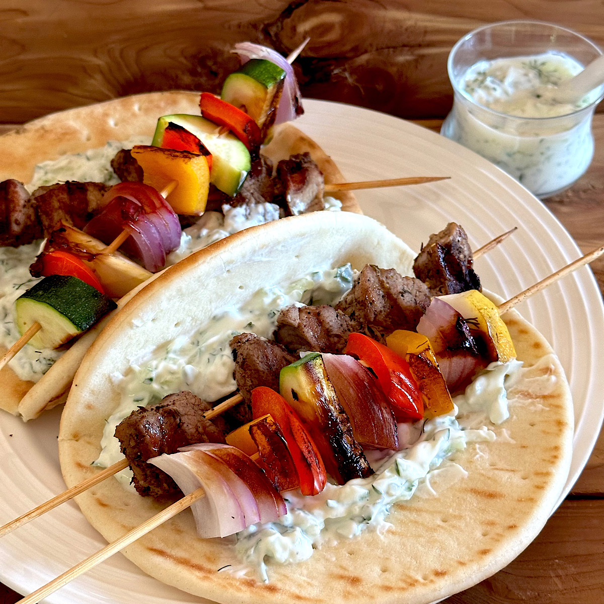 Pita sandwich with pork and vegetable kabobs.