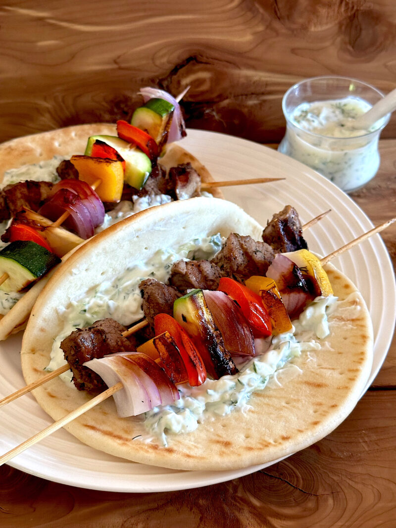 Pork and vegetable kabobs wrapped in pita with tzatziki sauce.