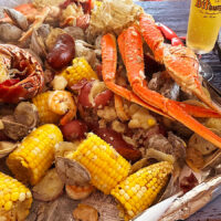 Seafood boil with beer and skillet cornbread cake.