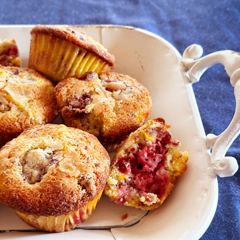 Raspberry corn breakfast muffins on a white tray