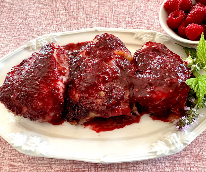 Raspberry chipotle sauce on baked chicken thighs.