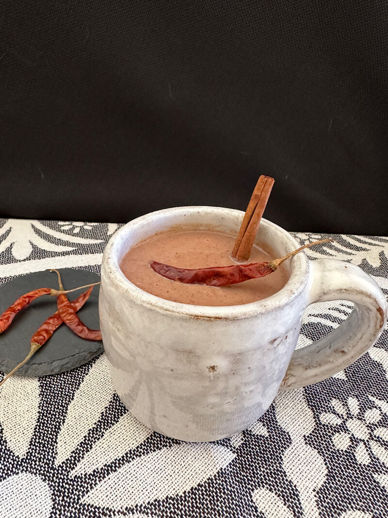 Portrait photo of Mexican hot chocolate with garnishes.