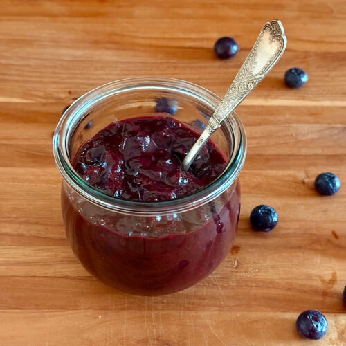 Blueberry Bourbon BBQ sauce in a jar with spoon.