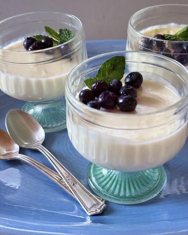 3 lemon posset desserts with blueberry topping and mint garnish from The Blueberry Cookbook by Dorothy Stainbrook
