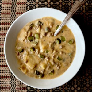 Cheeseburger and pickle soup in a white bowl in Dorothy Stainbrook's farm kitchen