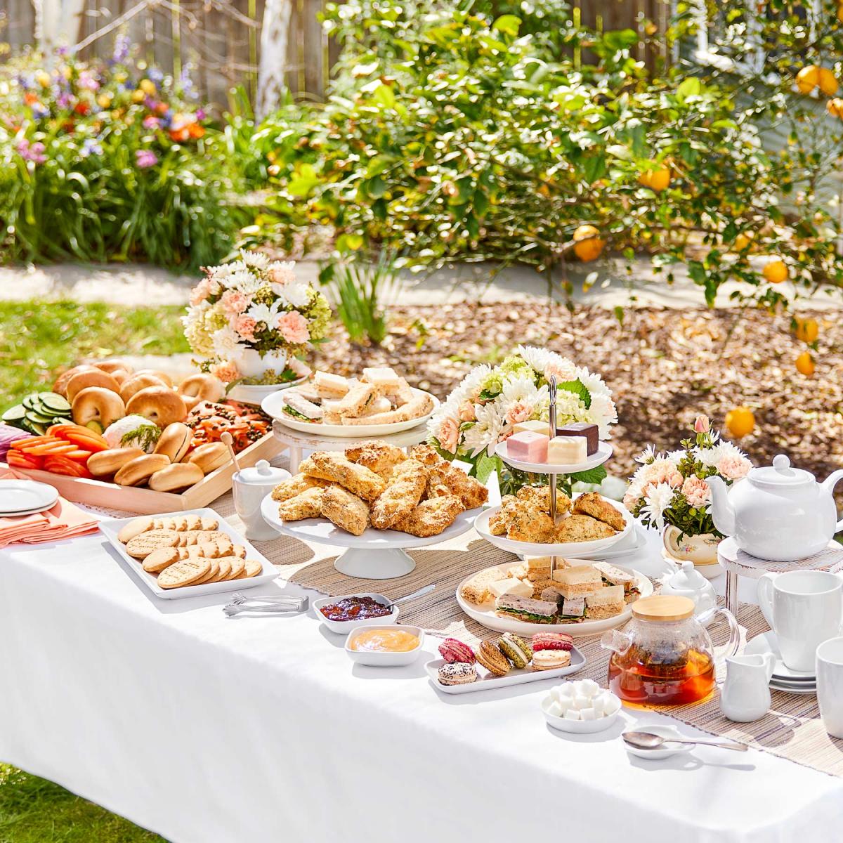 Outdoor garden tea party with tea, appetizers and pastries.