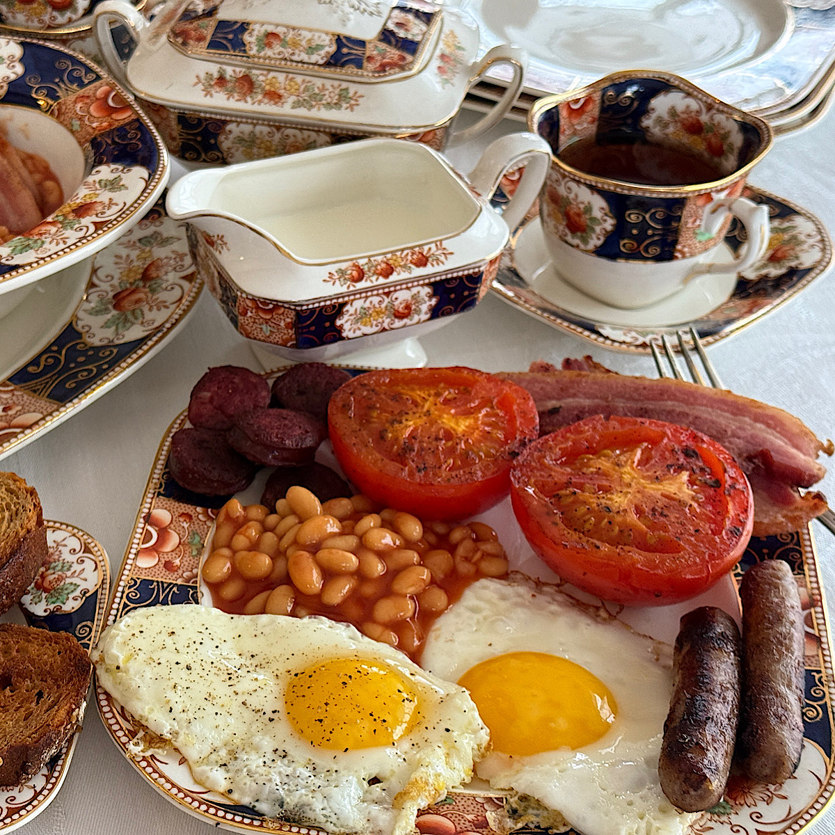 Full English breakfast with vintage china at HeathGlen's kitchen.
