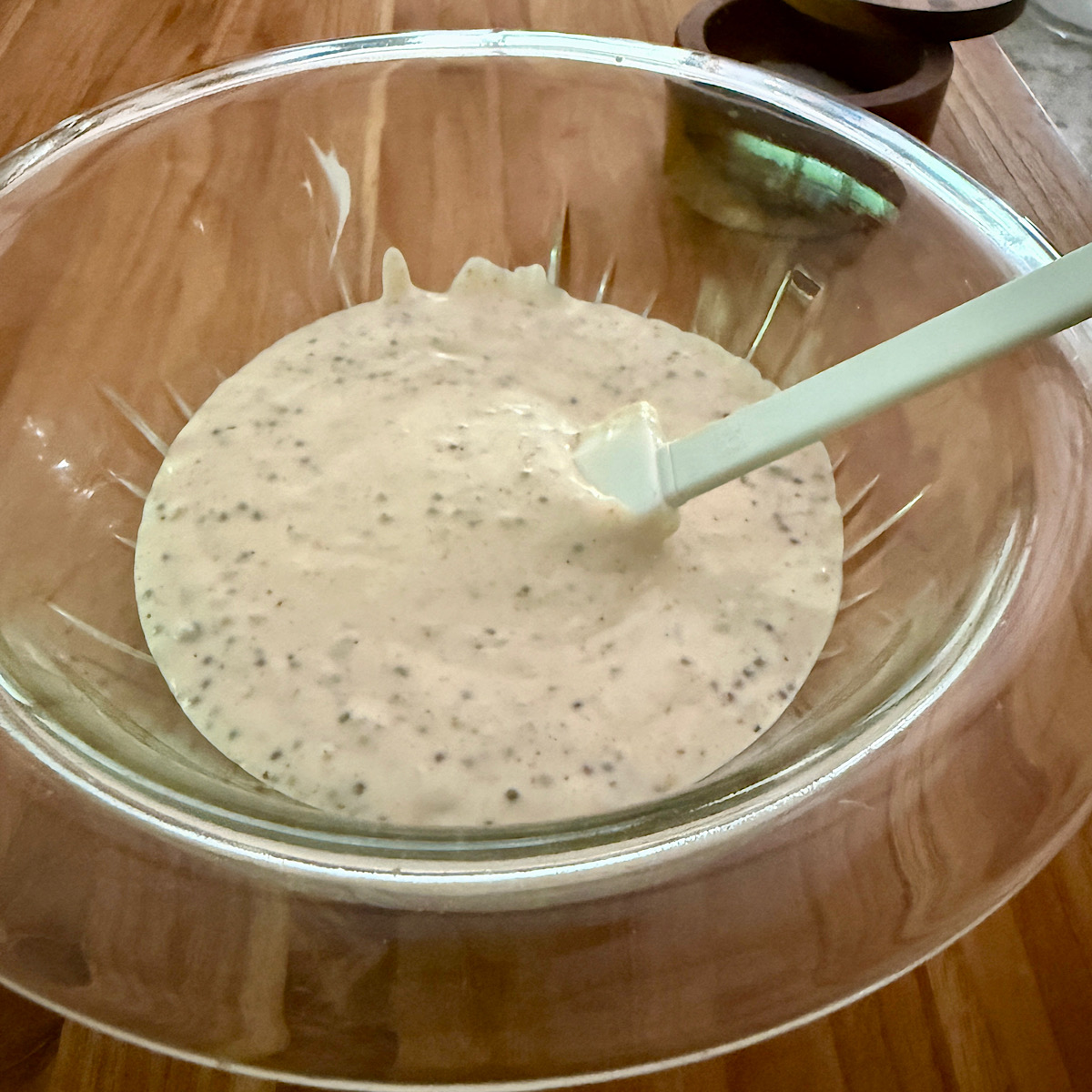 Remoulade sauce made with capers and pickle juice, mayonnaise, mustard and creole spices. Sauce is in a bowl and set aside for use in Oyster Po Boy sandwich.